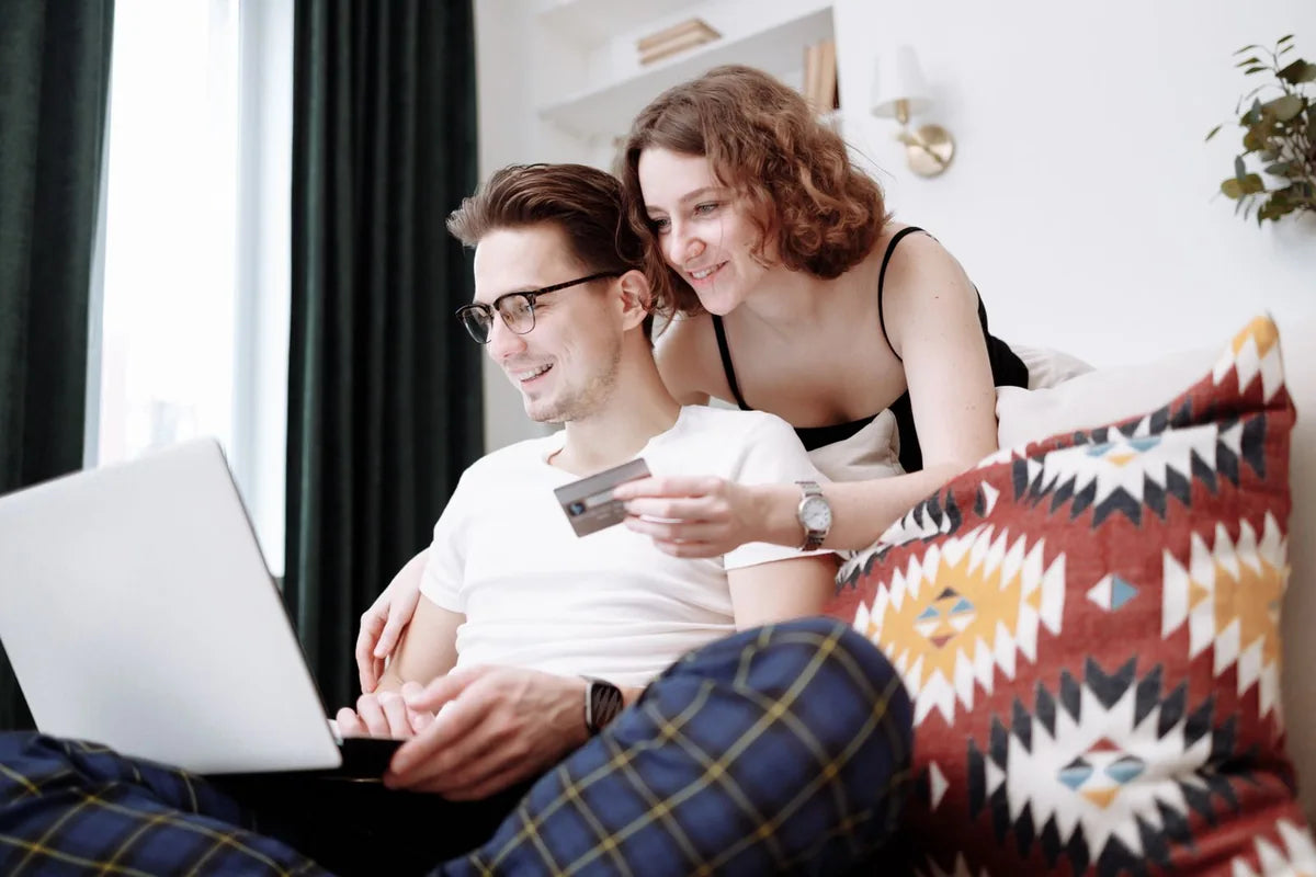 Couple reviewing a purchase together on a laptop